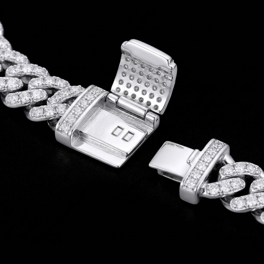 Close-up of an open Cuban bracelet clasp with adjacent stone-covered links