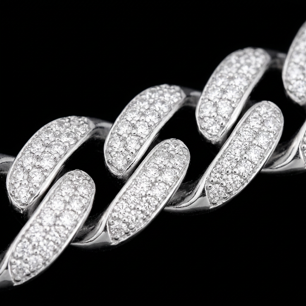 Close-up of stone-covered silver-tone Cuban bracelet links on a black background